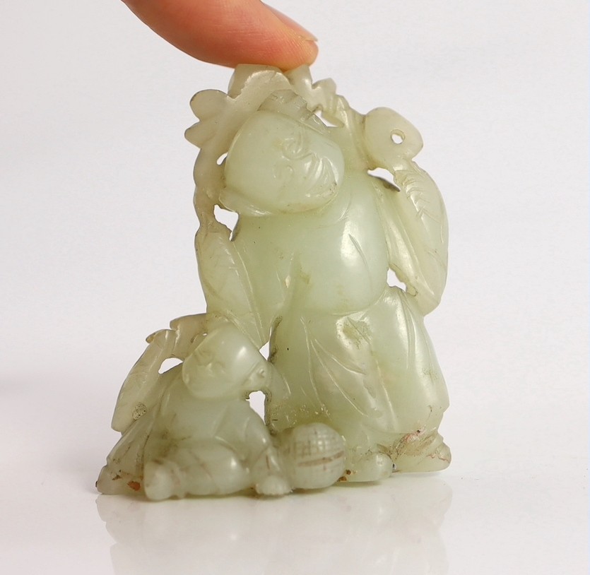 An assembled group of four Chinese pale celadon jade figures, 18th/19th century, displayed on two later wood 'rock-work' stands, total height approximately 19cm high